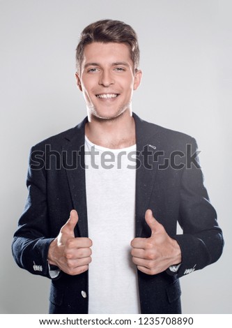 Cool businessman standing on grey background