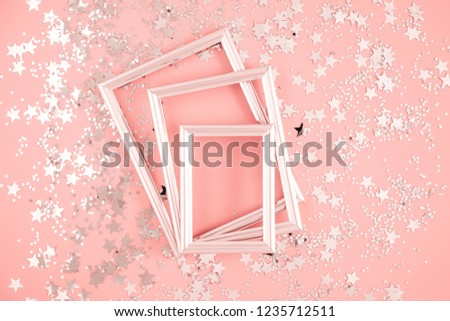 Festive elegant background. Blank photo frame on pastel pink background. Christmas, New Year, birthday concept. Flat lay, top view, copy space