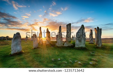 Sunset over the stone circle at Callanish on the Isle of Lewis in Scotland Royalty-Free Stock Photo #1235713642