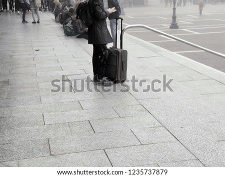 Tourist and his luggage at the railway station in Venice, Italy