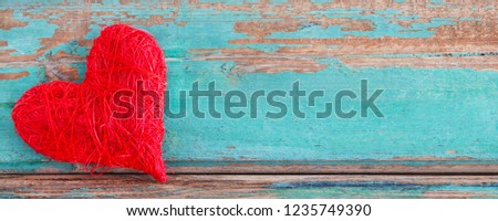 Red heart and wooden background
