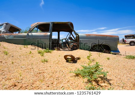 Wrecked cars lie abandoned in the desert surrounding Solitaire in Namibia.
