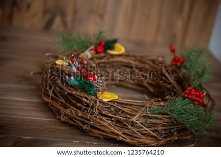 nest of the vine with the decor. Christmas wreath. Berries and candied fruits on the wreath.