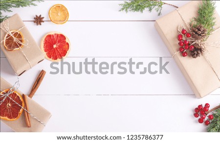 Gift boxes with Christmas decoration on white wooden background. Creative concept. Place for text.