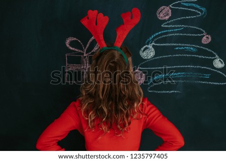 girl with reindeer ears and christmas decorations