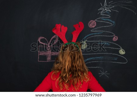 girl with reindeer ears and christmas decorations