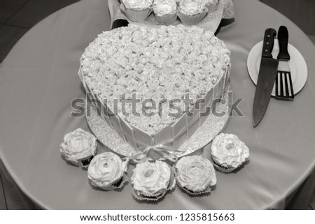 Luxury wedding cake in the shape of a heart. Delicious festive sweet cakes carries on the table. 