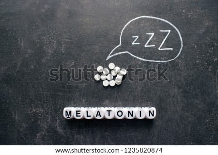 White pills in Z shape and text. Sleeping pills, hypnotic drugs, sedative, melatonin on dark night background Royalty-Free Stock Photo #1235820874