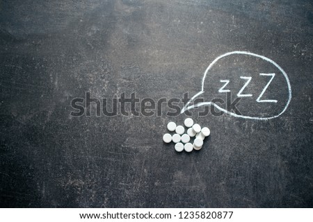 White pills in Z shape and text. Sleeping pills, hypnotic drugs, sedative, melatonin on dark night background Royalty-Free Stock Photo #1235820877