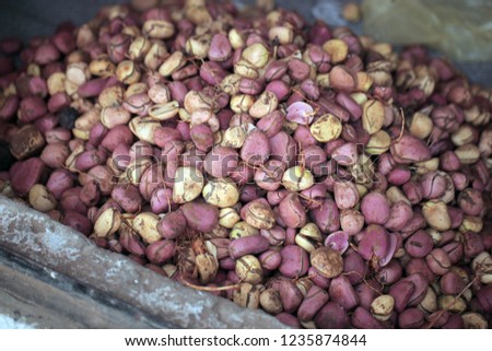 food background: close up aerial horizontal photography of african traditional nuts sold from a sack in the market, with natural light, in the Gambia, Africa on a summer day
