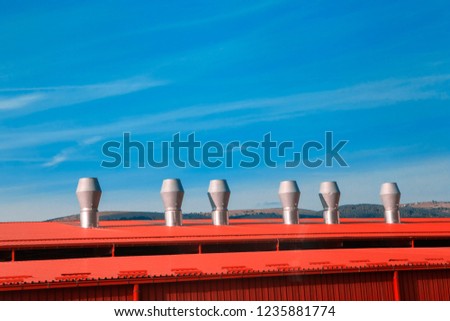 red roof and chimney against blue sky