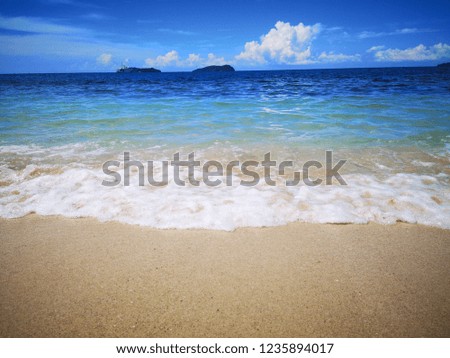 Sandy beach splashing water and wave