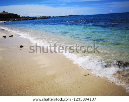 Sandy beach splashing water and wave