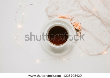 Cup of Coffee with Fairy Lights in a Neutral Background