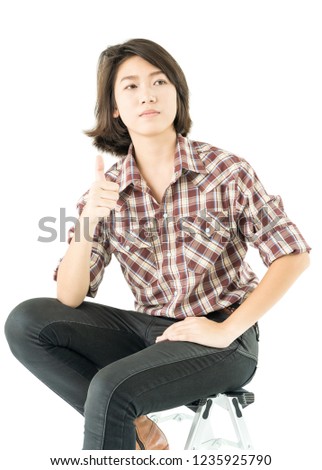 Young pretty woman in plaid shirt posing in studio with isolated on white background