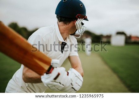 Cricketer on the field in action Royalty-Free Stock Photo #1235965975