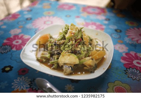 Papaya salad with field crab and pickled fish in white dish