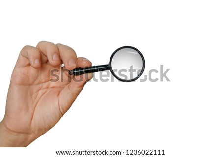 Magnifying glass in a hand isolated on a white background. Concept of searching, looking through magnifier, researching and scanning. Isolated male hand holding loupe. Using lens to look thoroughly.