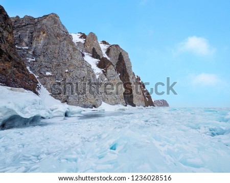 Fantastic Turquoise blue ice block and rock mountain at Lake Baikal in Olkhon Island, Russia. Defocus picture.