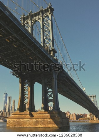 New York City, United States - Perspective view at one of the bases of Manhattan bridge from the Main Street park. Manhattan skyscrapers in the background .