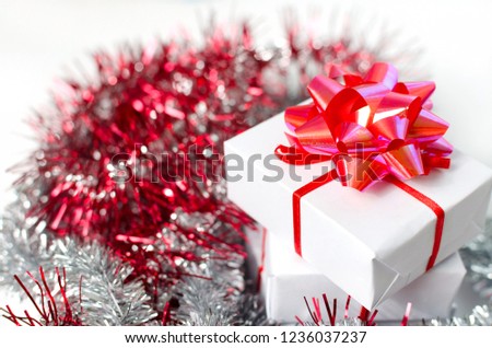 White gift box with red ribbon isolated on white background