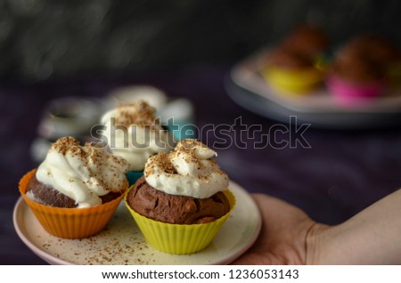 Colorful cupcakes on purple background