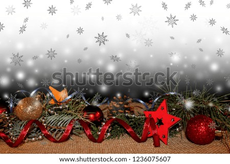  beautiful new year background with Christmas toys and fir twigs on the background of falling snowflakes