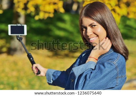A young girl of Asian appearance uled makes a selfie