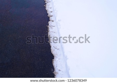 Black asphalt and snow white background. Two textures
