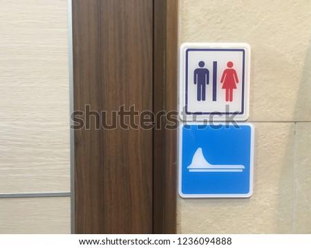 Badge sign of male and female toilets. White background tag The male figure is blue. Red women symbol And signs of the water privy or squat toilet. This image was taken from China.
