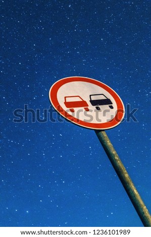 Road sign "Overtaking is prohibited" under the starry sky in Central Russia.