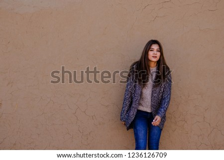 a young woman on the ancient wall background in Nisa
