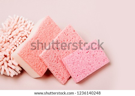 Sponges on pink background. Cleaning or housekeeping concept background. Copy space. Flat lay, Top view.