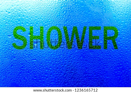 The inscription on the sweaty glass. The word "shower" written on glass
