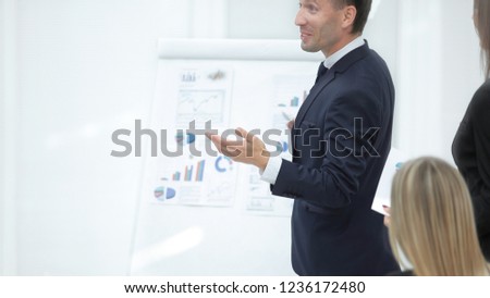 close up.businessman standing near a flipchart .photo with copy space