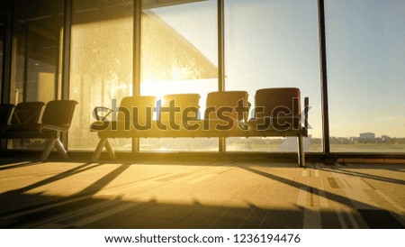 Silhouettes of bench in interior in airport lounge in the morning 