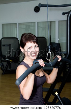 woman at the gym exercising on a machine