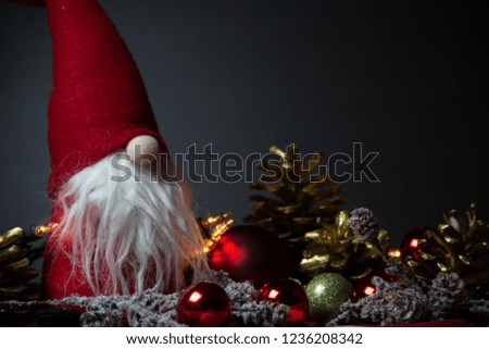 Christmas decor on dark Background. Adorable Little Santa Claus with Long White beard. Traditional Christmas decoration