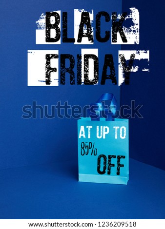 close up view of paper shopping bag on blue with black friday and 85 percents off discount