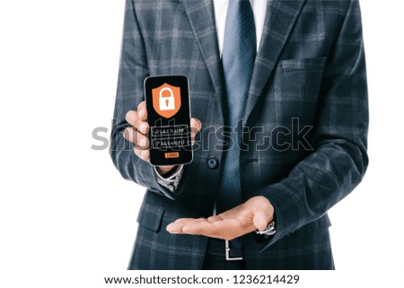 cropped shot of businessman in suit showing smartphone with cyber security sign on screen isolated on white