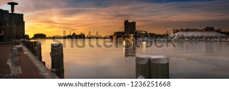 Winter sunrise over Baltimore USA harbor with ice on the water