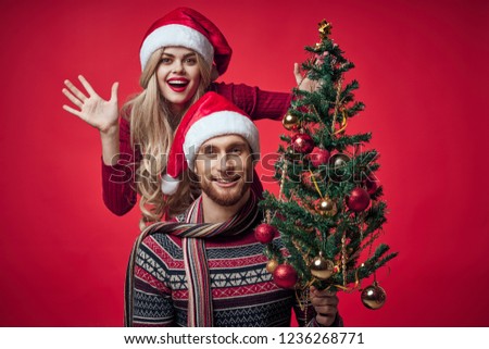 emotional woman and man with christmas tree                             