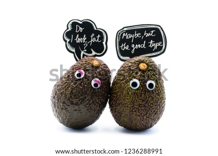 Romantic avocados couple with googly eyes and speech bubble as man and woman, funny food concept for creative projects.