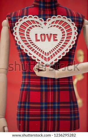 A mannequin holding Holidays greetings signs