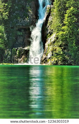 Waterfall and its reflection in the water Royalty-Free Stock Photo #1236303319