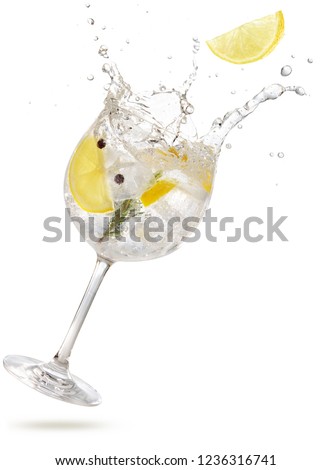 lemon slice falling into a splashing gintonic isolated on white Royalty-Free Stock Photo #1236316741