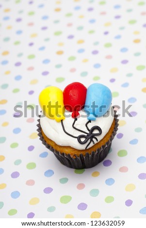 Image of a cupcake with balloon design.