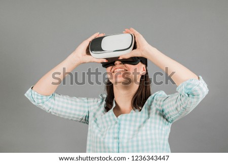 Woman with glasses of virtual reality. Future technology concept.  On a gray background