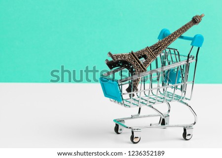 Eiffel Tower in a Shopping Cart. Travel concept