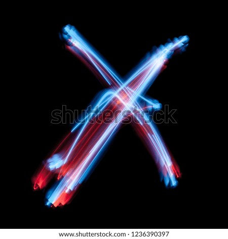 Letter X of the alphabet made from neon sign. The blue light image, long exposure with colored fairy lights, against a black background